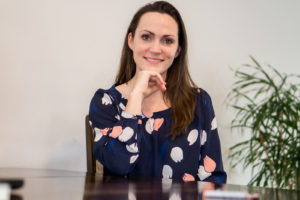 Owner Stephanie Ayala sitting at a table.