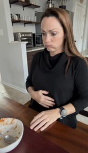 woman holding her belly showing how full she feels